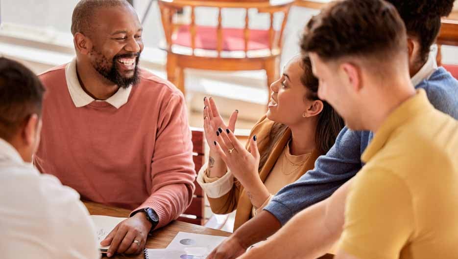 Creative teamwork, meeting and happy business people talking, in discussion and brainstorming ideas. Diversity, collaboration and workers smile for planning, marketing strategy and branding design.