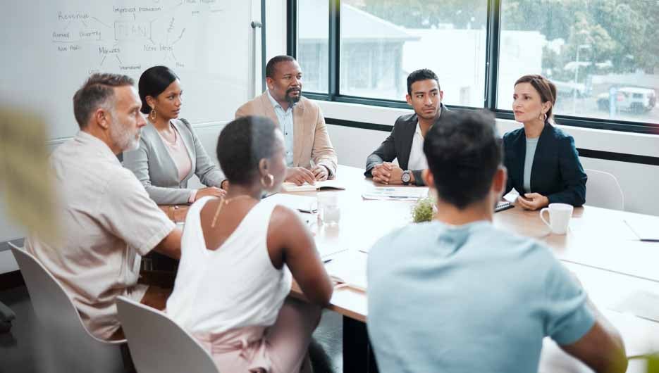 Business people, meeting and strategy in corporate planning, brainstorming or team discussion at the office. Group of employees in teamwork, collaboration or communication in conference at workplace.