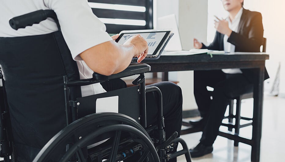 Man in wheelchair talking to woman