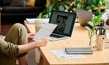Woman on laptop with coffee