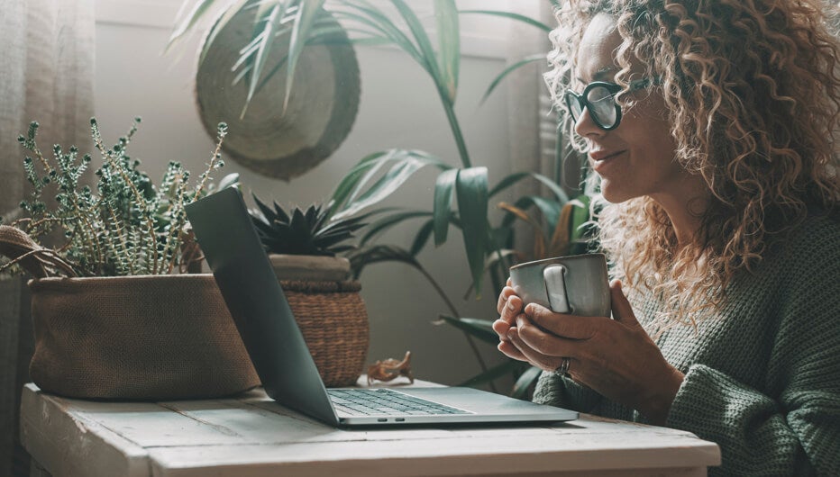 Woman on laptop with coffee