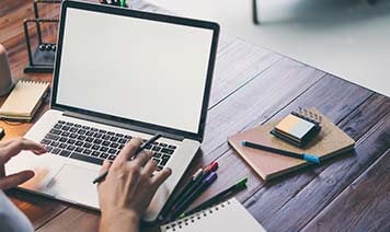 woman at home looking at laptop