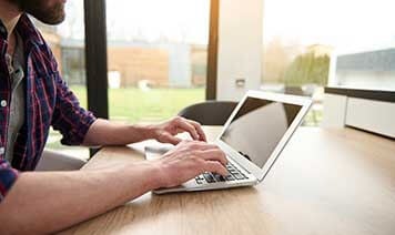 woman at home looking at laptop